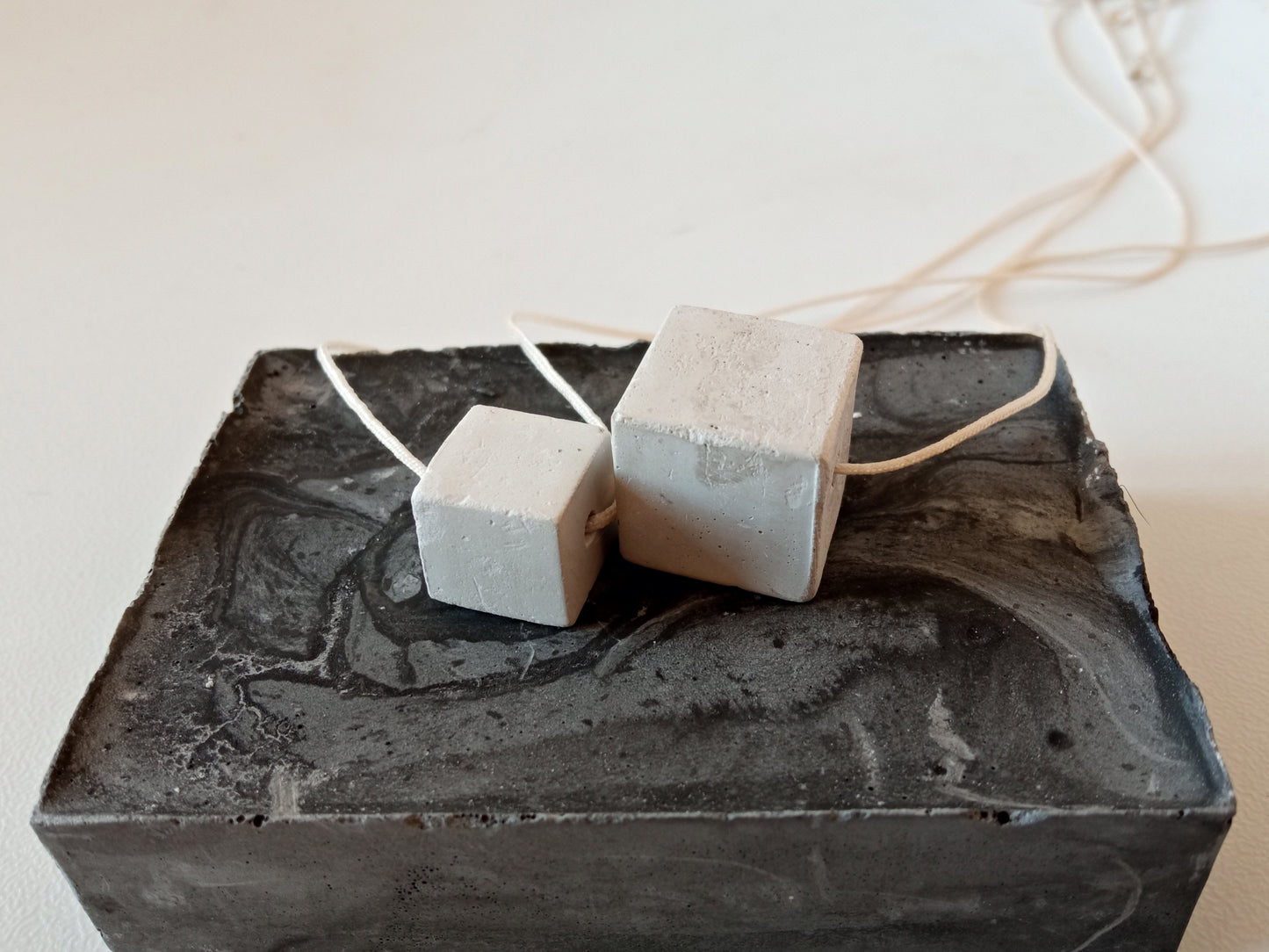 Concrete cube on a cord //gypsum plaster//
