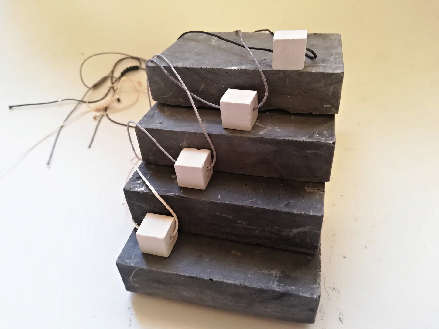 Concrete cube on a cord //gypsum plaster//