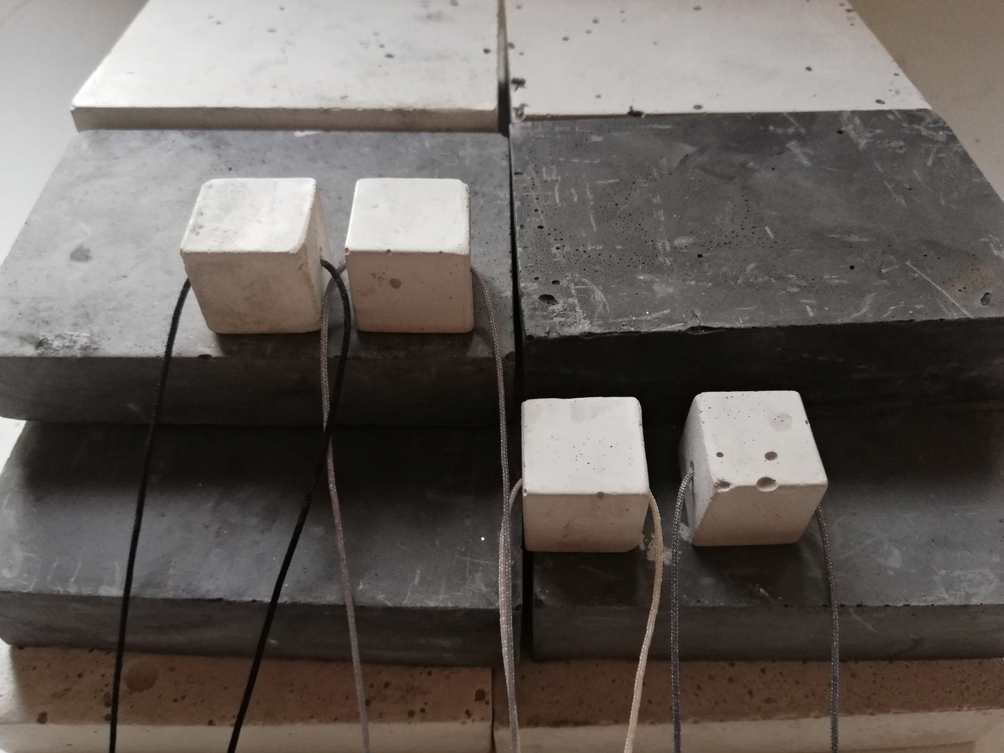 Concrete cube on a cord //gypsum plaster//