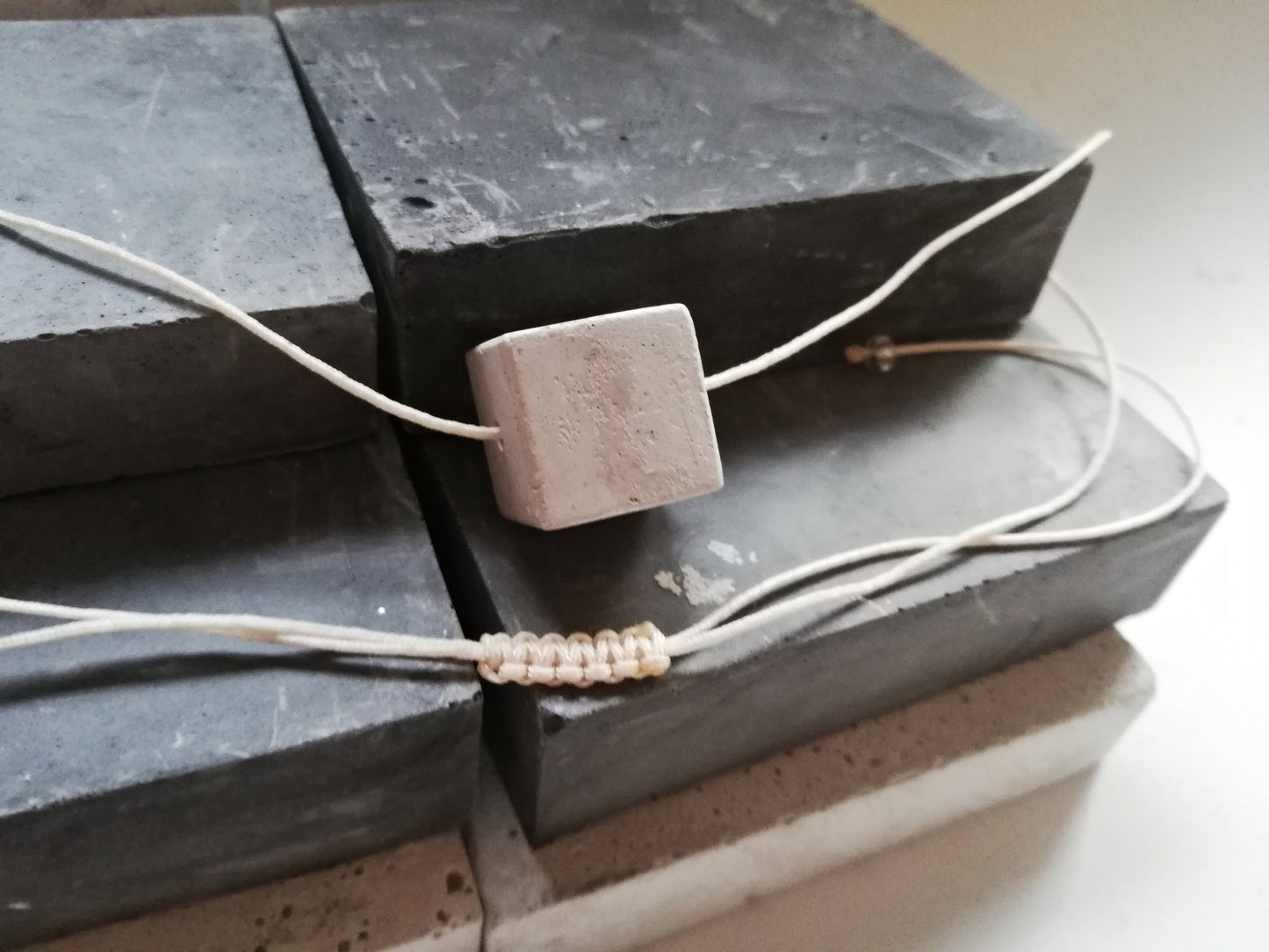 Concrete cube on a cord //gypsum plaster//