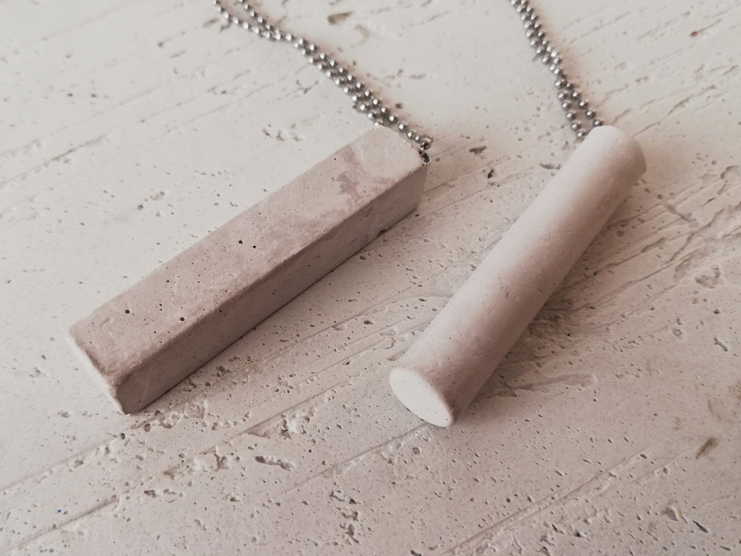 Concrete tube/rectangle on a ball chain //gypsum plaster//