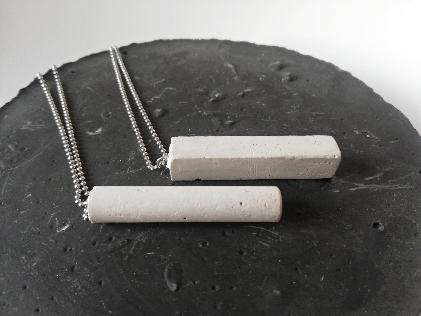 Concrete tube/rectangle on a ball chain //gypsum plaster//