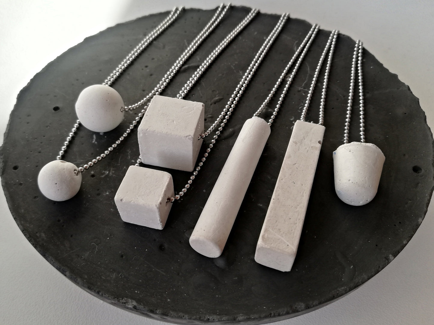 Concrete tube/rectangle on a ball chain //gypsum plaster//